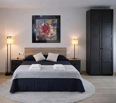 a bedroom with a large bed with two night stands at Apartamento Alba 1.1 in Lugo
