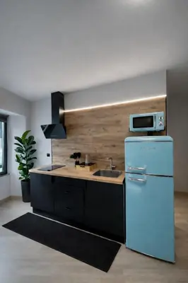 a kitchen with a white refrigerator and a sink at Apartamento Alba 1.1 in Lugo