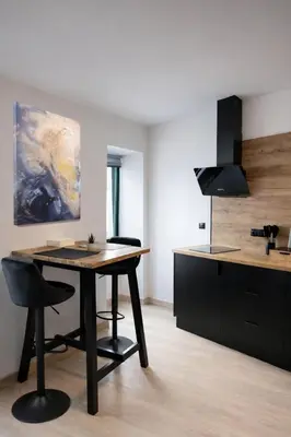 a kitchen with a table and chairs in a room at Apartamento Alba 1.1 in Lugo