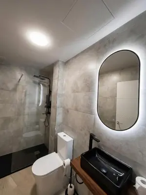 a bedroom with a door and a mirror at Apartamento Alba 1.1 in Lugo