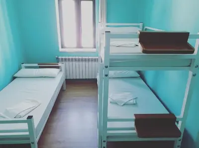 two bunk beds in a room with a window at ALBERGUE Pasiño A Pasiño in Portomarin