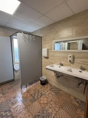 a bathroom with a shower and a sink and a mirror at ALBERGUE Pasiño A Pasiño in Portomarin