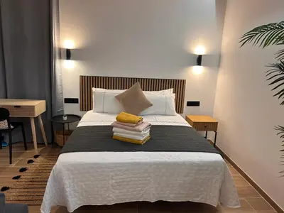 a bedroom with a bed with a pile of books at Bella Casa Araujo 2 in Teo