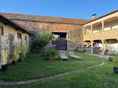 a yard with two chairs and a building at Bella Casa Araujo 2 in Teo