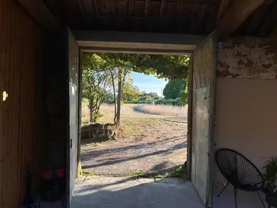 an open door of a house with a dirt road at Bella Casa Araujo 2 in Teo