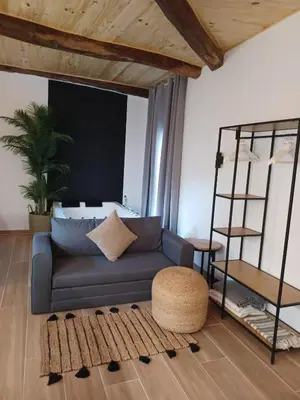 a living room with a blue couch and a ladder at Bella Casa Araujo 2 in Teo