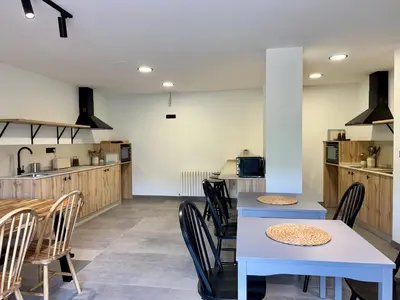 a kitchen and dining room with tables and chairs at Chulavista House by Kev in Parada del Sil