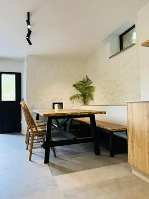 a dining room with a wooden table and chairs at Chulavista House by Kev in Parada del Sil