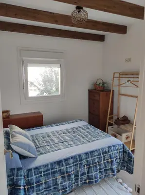 a bedroom with a bed and a window at Cesarina Urban House in Chantada