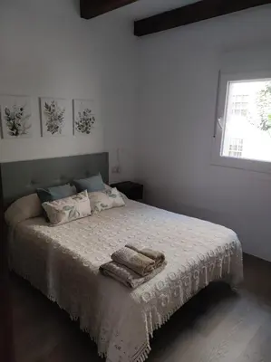 a bedroom with a bed with two towels on it at Cesarina Urban House in Chantada