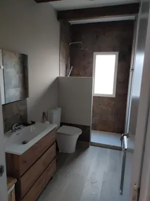 a bathroom with a sink and a toilet and a window at Cesarina Urban House in Chantada