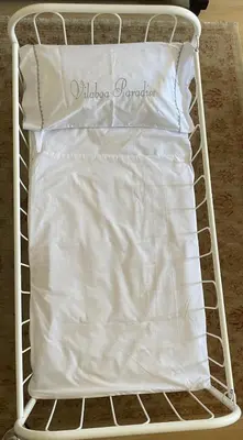 a bed with a white sheet and a pillow at Vilaboa Paradise in Villanueva