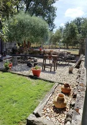 a garden with a table and some pots on rocks at Vilaboa Paradise in Villanueva