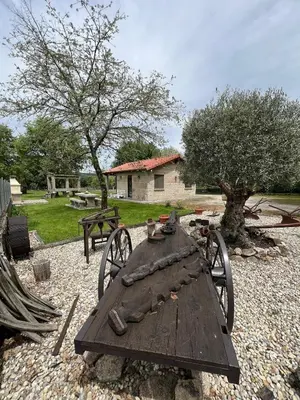 a wooden table with wagon wheels in a yard at Vilaboa Paradise in Villanueva