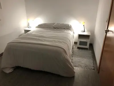 a bedroom with a large bed with two night stands at Cafú Casita in Coirós