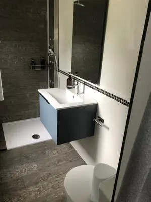 a bathroom with a sink and a toilet and a mirror at Cafú Casita in Coirós