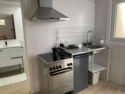 a kitchen with a stainless steel stove and a sink at Cafu loft in Coirós