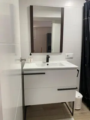 a bathroom with a white sink and a mirror at Cafu loft in Coirós