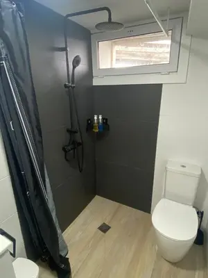 a small bathroom with a toilet and a window at Cafu loft in Coirós