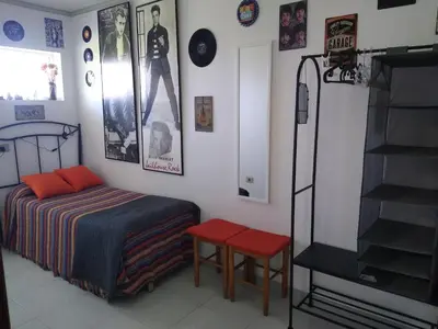 a bedroom with a bed and a staircase and posters at El Faro de Foz!!! Excelentes vistas,Tranquilo y Luminoso in Foz