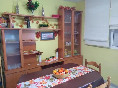 a room with a table with a bowl of fruit on a table at El Faro de Foz!!! Excelentes vistas,Tranquilo y Luminoso in Foz