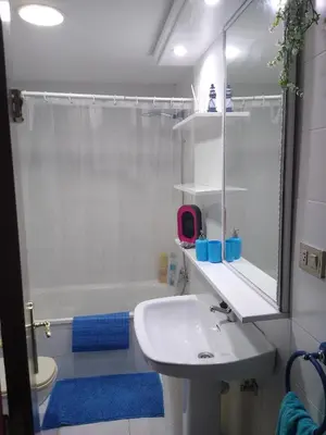 a white bathroom with a sink and a shower at El Faro de Foz!!! Excelentes vistas,Tranquilo y Luminoso in Foz