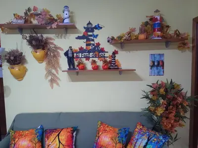 a living room with a couch and shelves on the wall at El Faro de Foz!!! Excelentes vistas,Tranquilo y Luminoso in Foz