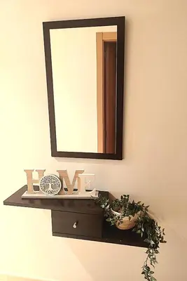 a mirror on a wall with a shelf with a plant at Amanecer en Costa Reinante Spa in San Miguel de Reinante