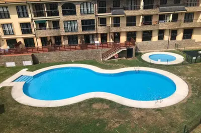 a large swimming pool in front of a building at Amanecer en Costa Reinante Spa in San Miguel de Reinante
