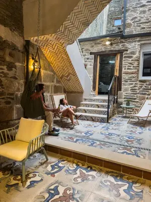 a man and a child sitting on a bench in a room at Go Compostela Apartamento 4 pax in Sarria