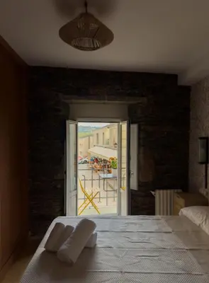 a bedroom with a bed and a view of a patio at Go Compostela Apartamento 4 pax in Sarria