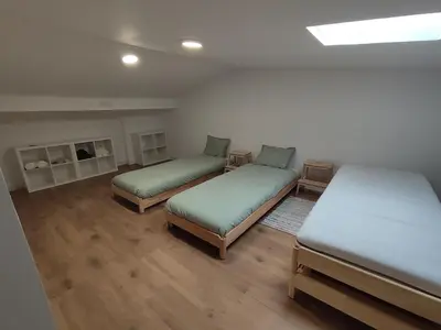 a room with two beds and a fireplace at MeraVilla in Oleiros