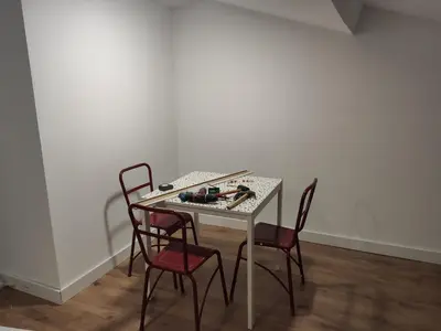 a table with four chairs in a room at MeraVilla in Oleiros