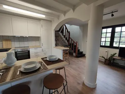 a kitchen with a counter and a table with chairs at MeraVilla in Oleiros