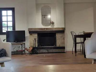 a living room with a fireplace and a television at MeraVilla in Oleiros