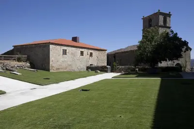 an external view of a building with a grass yard at Parador Castillo de Monterrei in Monterrei