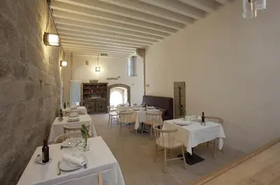 a dining room with white tables and chairs at Parador Castillo de Monterrei in Monterrei