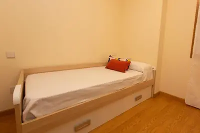 a small bedroom with a bed in a room at Apartagal-Océano V Barreiros in Barreiros