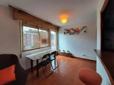 a living room with a table and a window at Apartamento Playa de Ber Ber-Mar in Perbes
