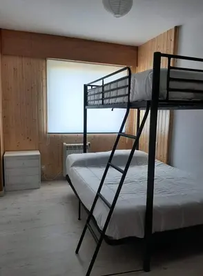 a bedroom with two bunk beds and a window at Apartamento Playa de Ber Ber-Mar in Perbes