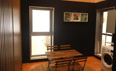 a table and chairs in a room with a window at Casa do Balneario in Arnoia