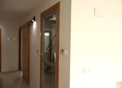 a hallway with a glass door in a building at Casa do Balneario in Arnoia