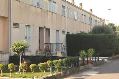 a building with flags and plants in front of it at Casa do Balneario in Arnoia
