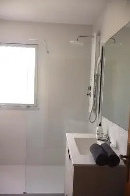 a bathroom with a sink and a shower and a mirror at Casa do Balneario in Arnoia