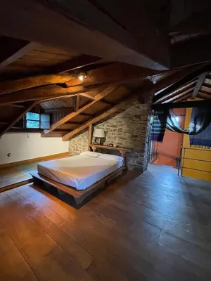 a bedroom with a large bed in an attic at La Brisa Del Bierzo in Toral de Merayo