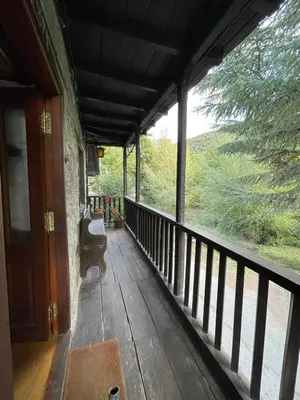 a porch of a house with a view of the woods at La Brisa Del Bierzo in Toral de Merayo