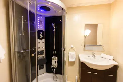 a bathroom with a shower with a controller in it at Apartagal-Urbanización Foz II in Foz