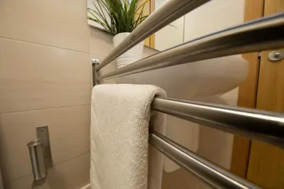 a towel rack in a bathroom with a towel at Apartagal-Urbanización Foz II in Foz