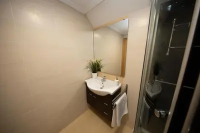 a bathroom with a sink and a mirror at Apartagal-Urbanización Foz II in Foz