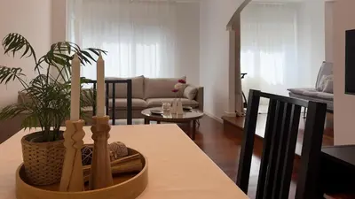 a living room with a table with a potted plant at VIVIENDA OLGA, piso tranquilo con parking a 10 min de Santiago in Sigüeiro